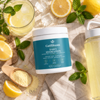 GutBloom Daily Hydration flat lay with lemons, mint, ice and lemonade